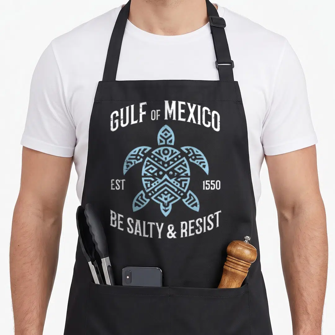 Resist mexico apron - Distressed sea turtle graphic with arched text GULF OF MEXICO and BE SALTY RESIST — shown on a black cotton canvas apron against a white background