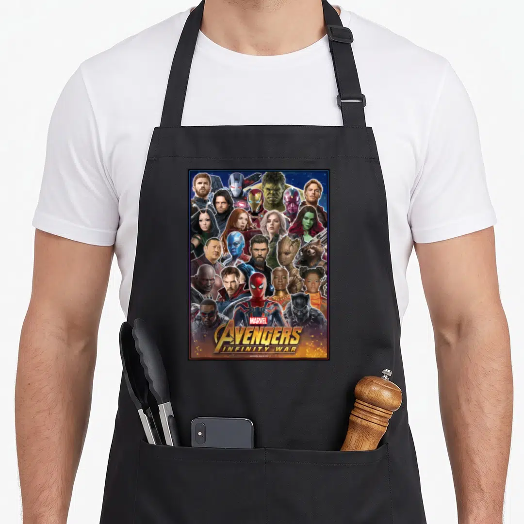 Headshot infinity apron - Collage of superhero faces in blue, gold, and red with stacked Marvel Avengers Infinity War — shown on a black cotton canvas apron against a white background