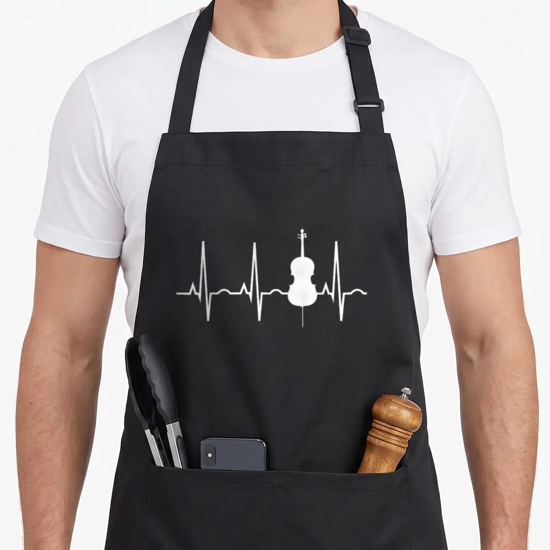 Cellistst cello apron - White cello shape integrated into a white EKG heartbeat pulse line on grey background — shown on a black cotton canvas apron against a white background