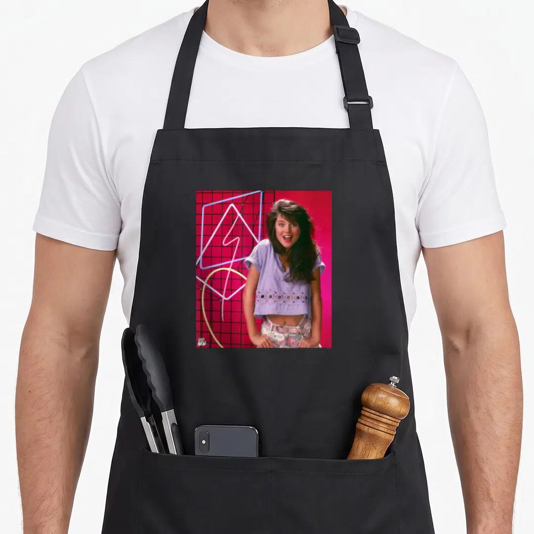 Kapowski bell apron - Photo of a woman in lavender top against red background with blue and pink neon geometric shapes — shown on a black cotton canvas apron against a white background