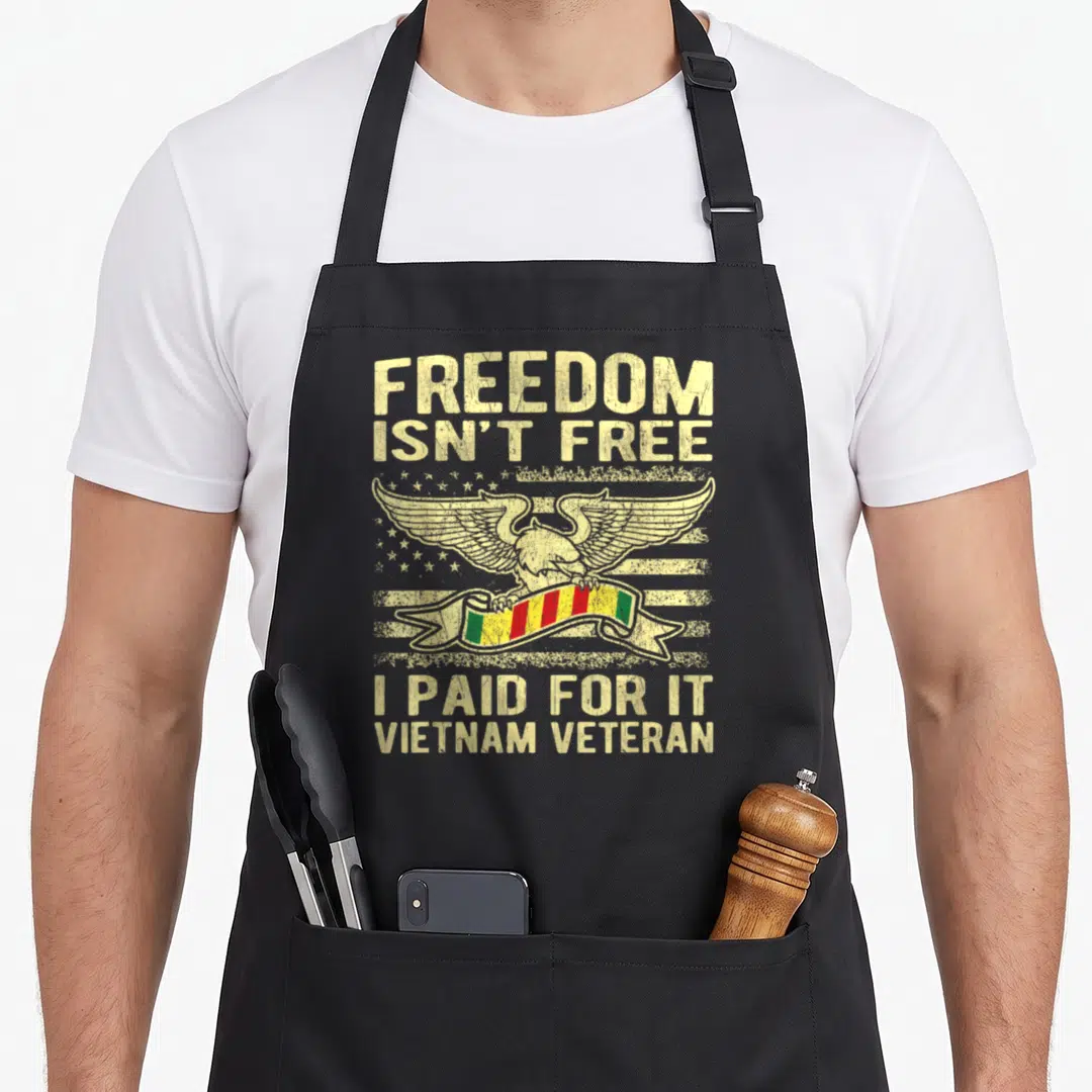 Freedom child expires apron - Distressed eagle holding red yellow green ribbon with Vietnam Veteran text over flag — shown on a black cotton canvas apron against a white background