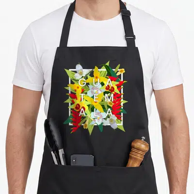 Flower guatemala guatemalan aprons - Stacked GUA TEM ALA text over yellow red and green tropical flowers in white frame — shown on a black cotton canvas apron against a white background