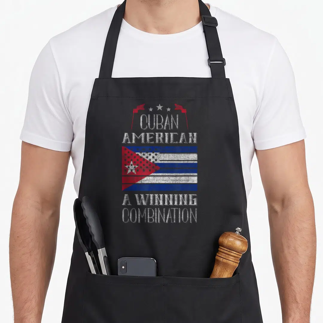Winning pride apron - Distressed Cuban American text above a red white and blue blended flag with stars — shown on a black cotton canvas apron against a white background
