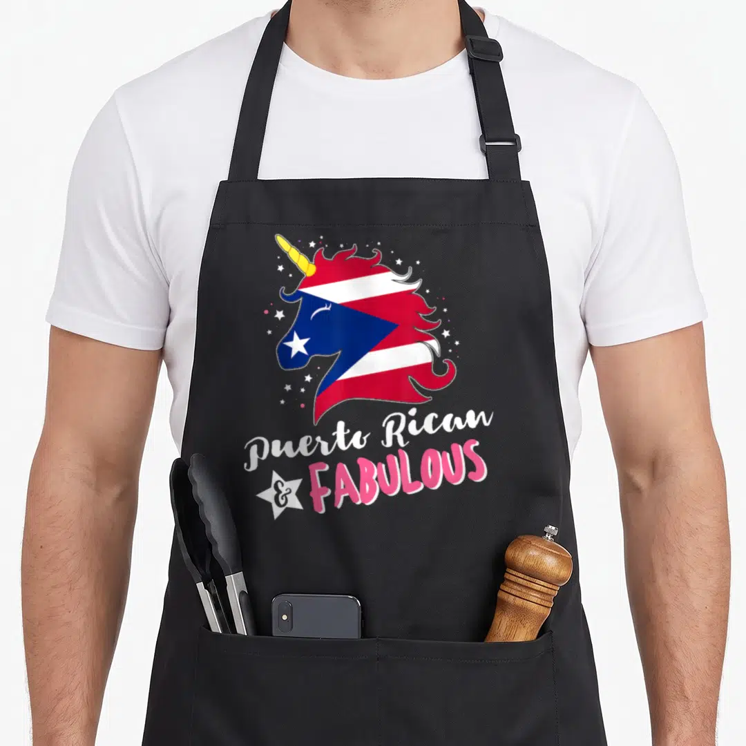 Puerto unicorn apron - Cartoon unicorn head with Puerto Rico flag pattern and text Puerto Rican & Fabulous surrounded — shown on a black cotton canvas apron against a white background