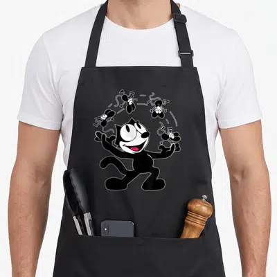 Juggling cartoon apron - Black cat with red tongue surrounded by four leaping mice in vintage cartoon style — shown on a black cotton canvas apron against a white background