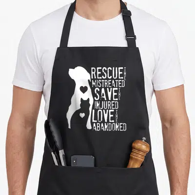 Cat grill rescue apron - White dog silhouette containing grey cat with stacked text about rescuing and saving animals — shown on a black cotton canvas apron against a white background