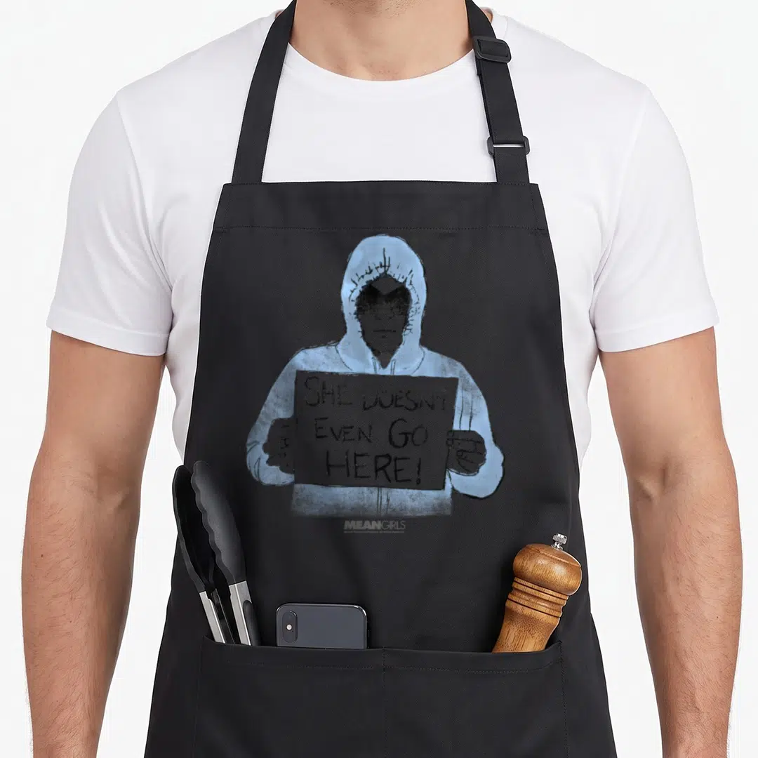 Mean better good apron - Line art of person in blue hoodie holding sign reading She Doesn't Even Go Here — shown on a black cotton canvas apron against a white background
