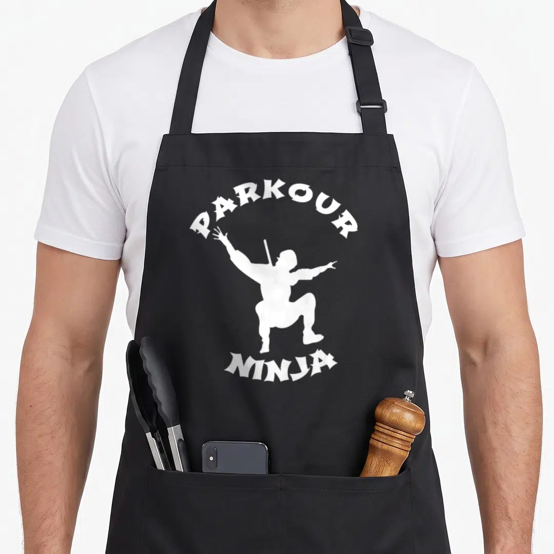 Runner urban apron - White ninja silhouette with PARKOUR arched above and NINJA below in gothic font — shown on a black cotton canvas apron against a white background