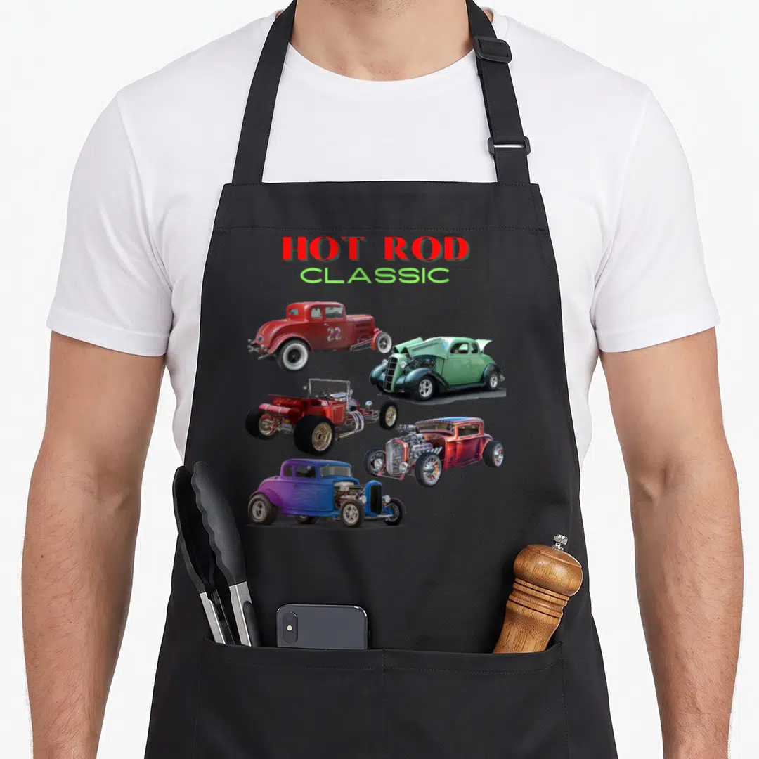 Car antique apron - Five realistic hot rod cars in red, green, purple, and blue below stacked HOT ROD CLASSIC text — shown on a black cotton canvas apron against a white background