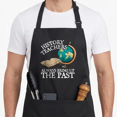 Alway teacher apron - Globe and open book with History Teachers Always Bring Up The Past text — shown on a black cotton canvas apron against a white background