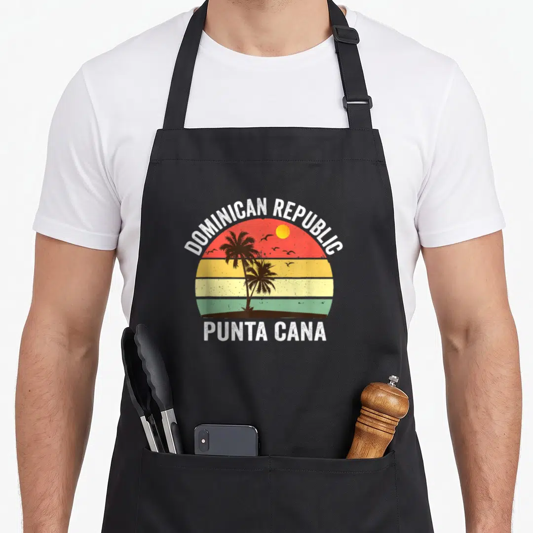 Beach punta cana apron - Retro sunset dome with palm trees and DOMINICAN REPUBLIC text — shown on a black cotton canvas apron against a white background
