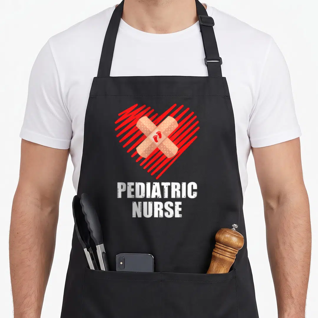 Cute pediatric nurse apron - Red striped heart with crossed tan bandages and small red footprints above white PEDIATRIC — shown on a black cotton canvas apron against a white background