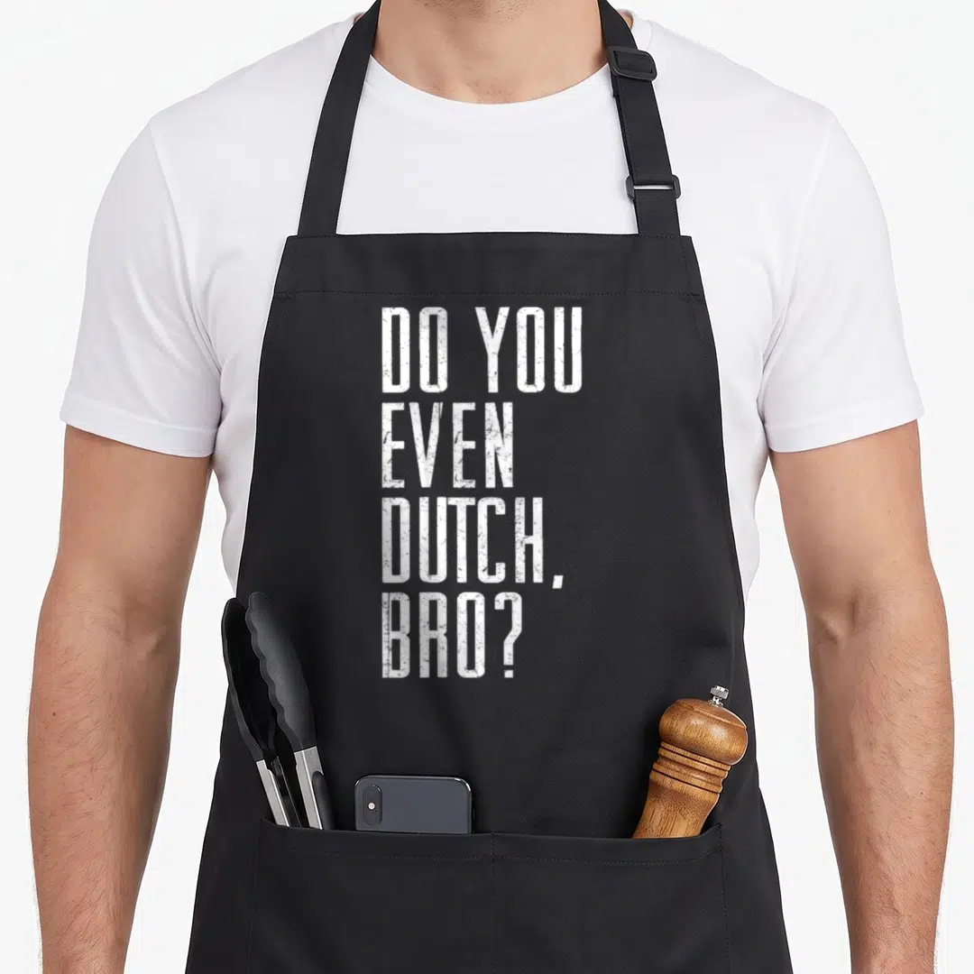 College joke apron - White stacked text DO YOU EVEN DUTCH BRO on dark background — shown on a black cotton canvas apron against a white background