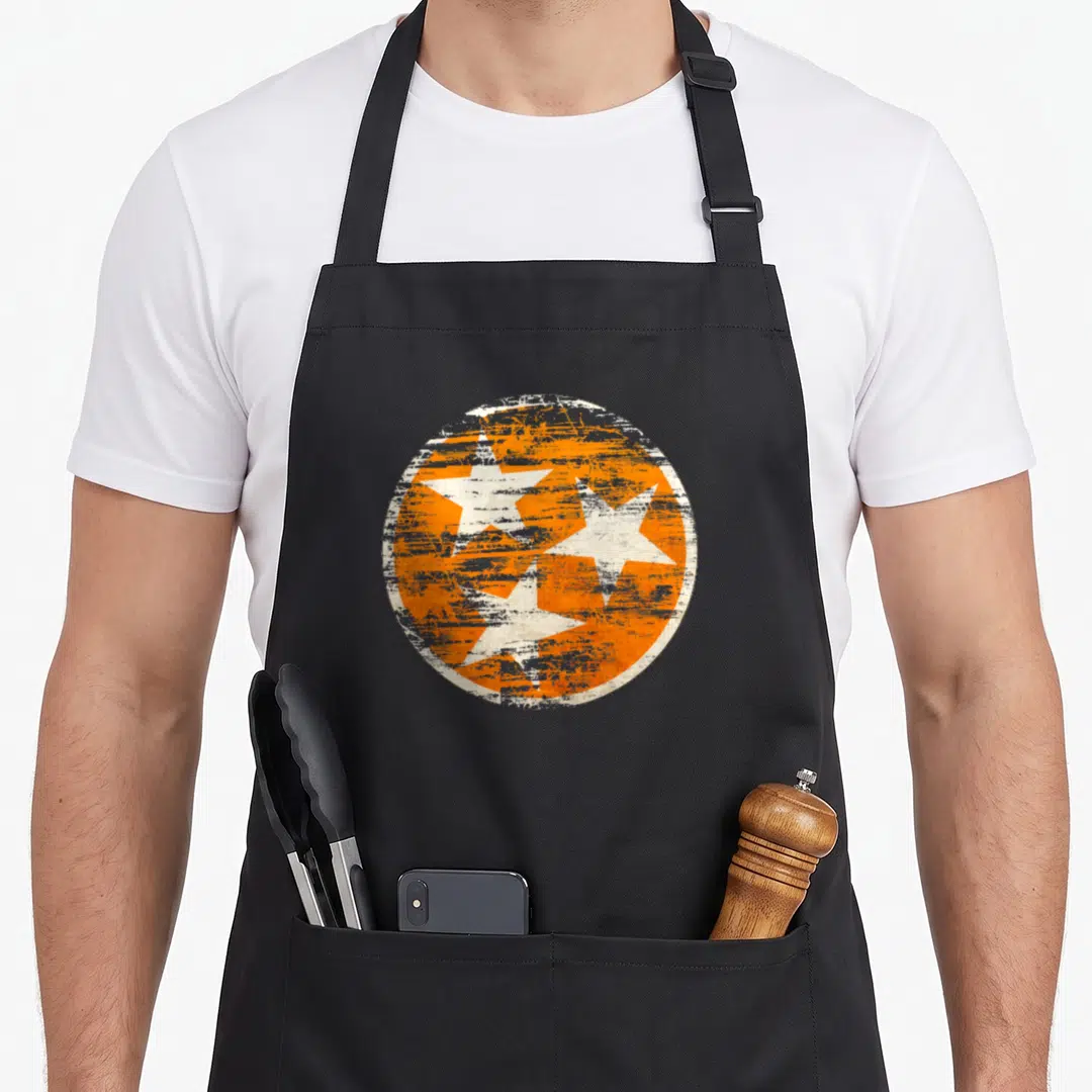 State flag distressed apron - Three white stars inside an orange distressed circle on canvas apron — shown on a black cotton canvas apron against a white background