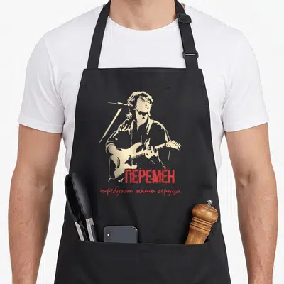 Wiktor poet apron - Beige guitarist silhouette with red Cyrillic text about changes and hearts — shown on a black cotton canvas apron against a white background