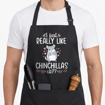 Chinchilla pet animal apron - Cartoon grey chinchilla with pink hearts and white text reading I just really like — shown on a black cotton canvas apron against a white background