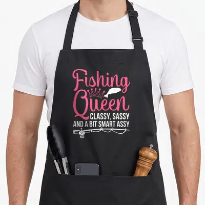 Fish bass fishing aprons - Pink Fishing Queen text with crown, fish, and rod graphic — shown on a black cotton canvas apron against a white background