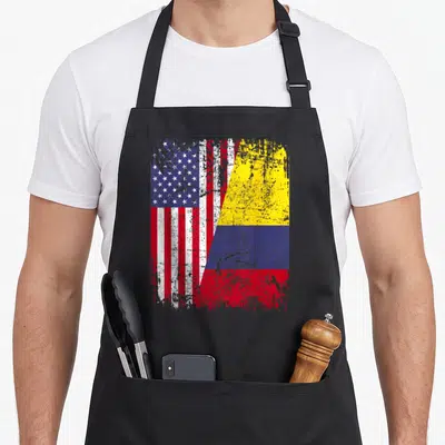 Colombia american flag apron - Distressed split design showing US stars stripes next to Colombian yellow blue and red — shown on a black cotton canvas apron against a white background