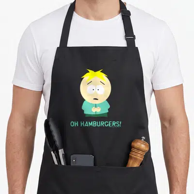 Hamburger butter apron - Cartoon boy with yellow hair and OH HAMBURGERS text in light blue — shown on a black cotton canvas apron against a white background