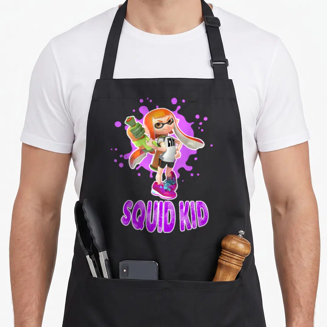 Splat squid lady apron - Inkling girl holding green weapon over purple splatter with SQUID KID text below — shown on a black cotton canvas apron against a white background