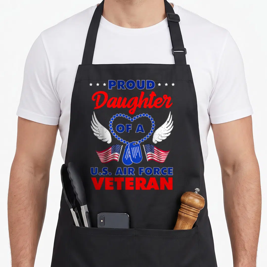Daughter zeewire air force veteran family apron - Red white blue distressed heart dog tags USA flags text Proud — shown on a black cotton canvas apron against a white background