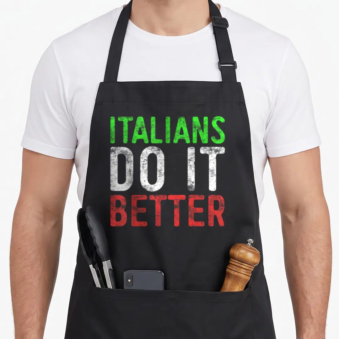 Better pride italian aprons - Stacked green white and red text reading ITALIANS DO IT BETTER — shown on a black cotton canvas apron against a white background