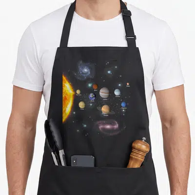 Realistic christmas apron - Solar system photo with labeled planets sun and galaxies on grey background — shown on a black cotton canvas apron against a white background