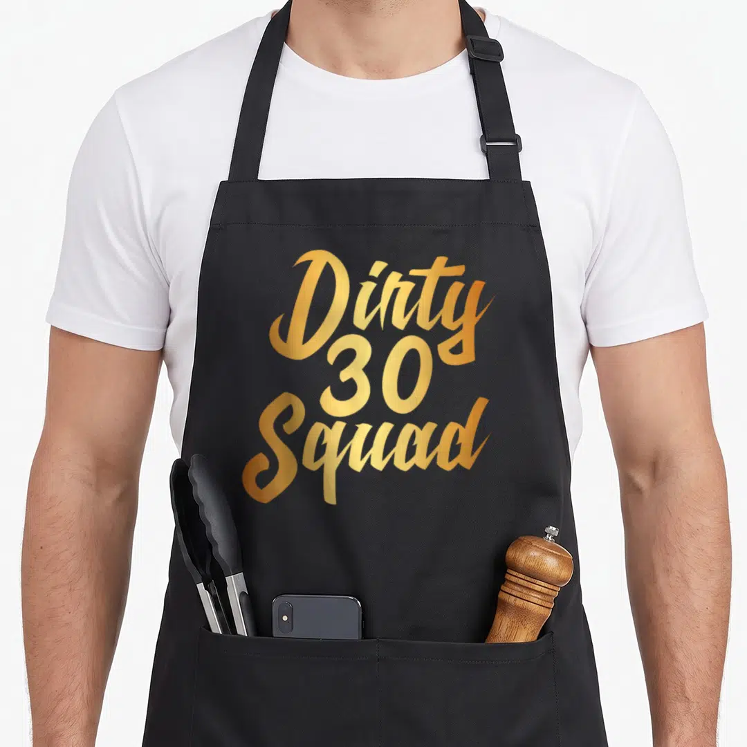 Thirty squad funny dirty aprons - Gold script text Dirty 30 Squad stacked vertically — shown on a black cotton canvas apron against a white background