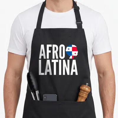 Caribbean pride apron - Stacked AFRO LATINA text next to a woman's head silhouette filled with Panama flag colors — shown on a black cotton canvas apron against a white background