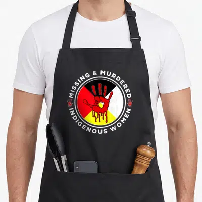 Mmiw wheel apron - Red handprint on four color quadrants surrounded by Missing & Murdered Indigenous Women text — shown on a black cotton canvas apron against a white background