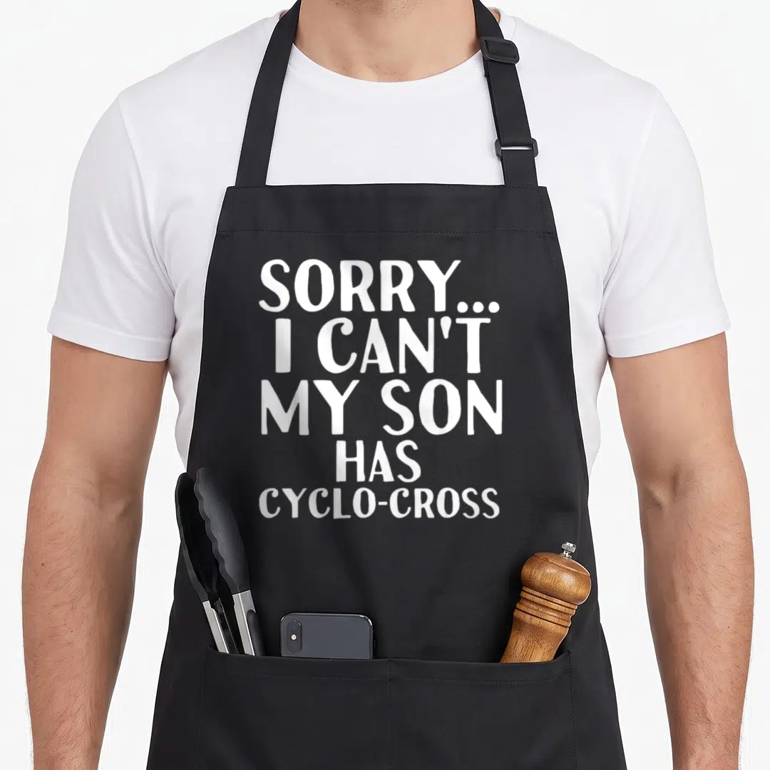 Cyclo cross apron - White stacked text reading Sorry I Can't My Son Has Cyclo-cross on grey background — shown on a black cotton canvas apron against a white background
