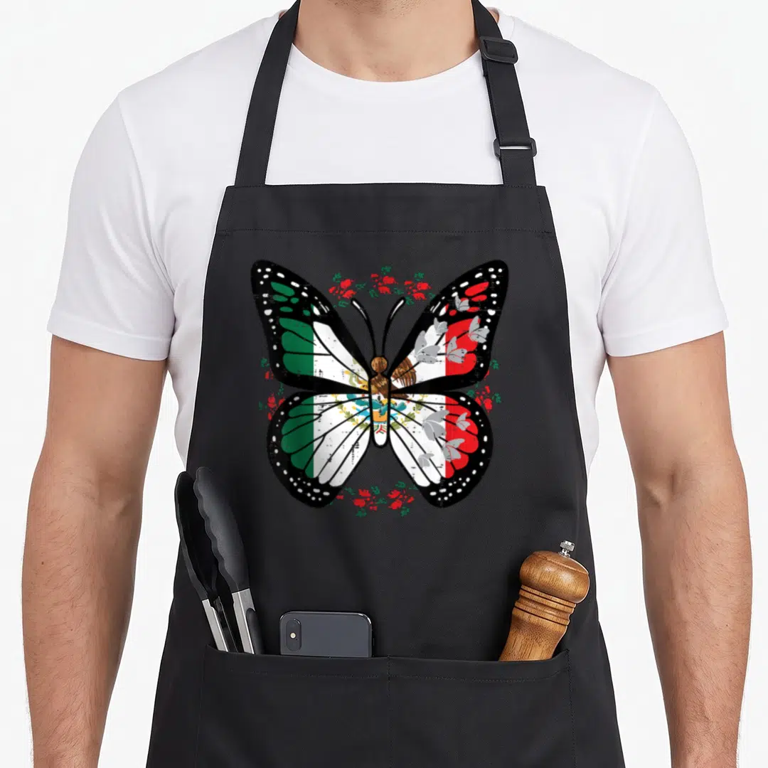 Independence mexican apron - distressed butterfly with Mexican flag wings surrounded by red flower wreath — shown on a black cotton canvas apron against a white background
