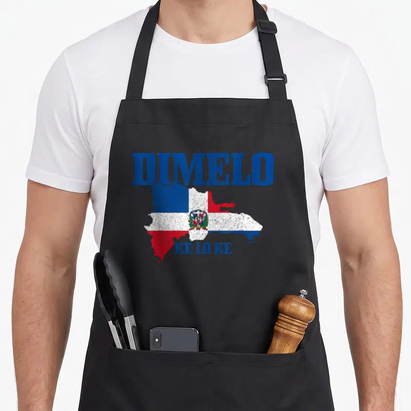Dimelo dominican pride apron - Distressed map of Dominican Republic filled with flag colors, DIMELO above, KE LO KE — shown on a black cotton canvas apron against a white background