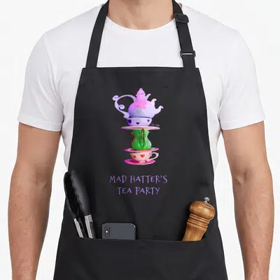 Hatter tea party aprons - Watercolor stack of purple teapot, green vase, and pink cup with hearts and text — shown on a black cotton canvas apron against a white background