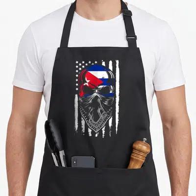 Cuban skull american flag apron - Distressed skull with Cuban flag colors and bandana against stars and stripes — shown on a black cotton canvas apron against a white background