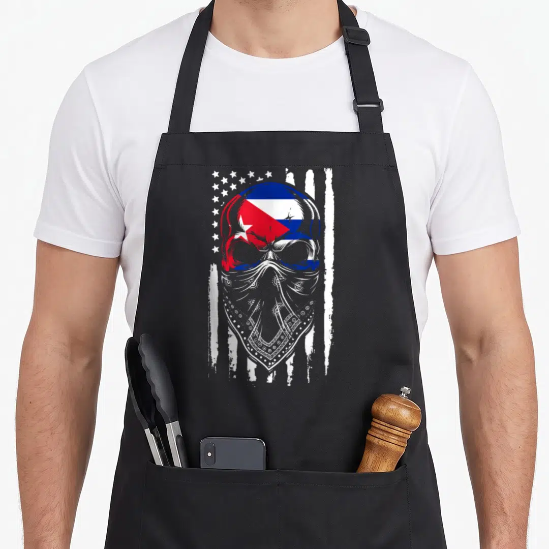 Cuban skull american flag apron - Distressed skull with Cuban flag colors and bandana against stars and stripes — shown on a black cotton canvas apron against a white background