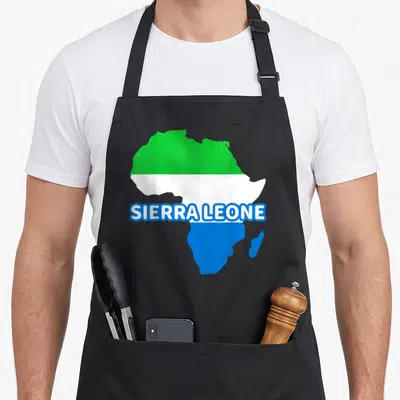 Sierra pride apron - Africa map filled with green white blue flag stripes and SIERRA LEONE text centered — shown on a black cotton canvas apron against a white background
