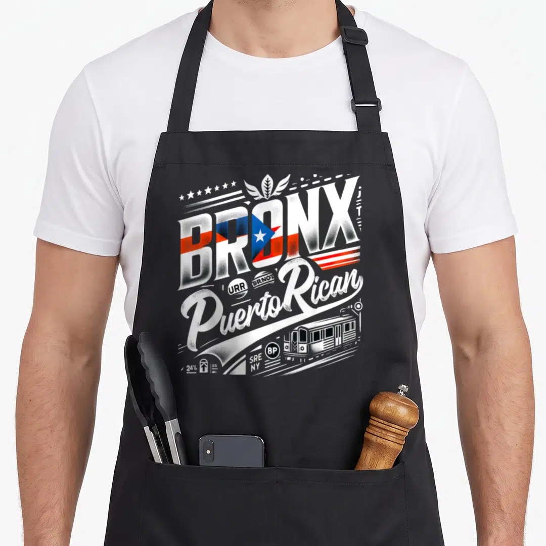 Puerto new york apron - Retro BRONX text with flag fill, Puerto Rican script, and 8P subway train graphic — shown on a black cotton canvas apron against a white background