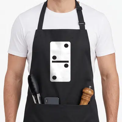 Domino halloween apron - White domino tile with four black dots and center line on black background — shown on a black cotton canvas apron against a white background
