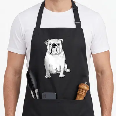 Owner english chef aprons - Black line art drawing of a sitting bulldog facing forward — shown on a black cotton canvas apron against a white background