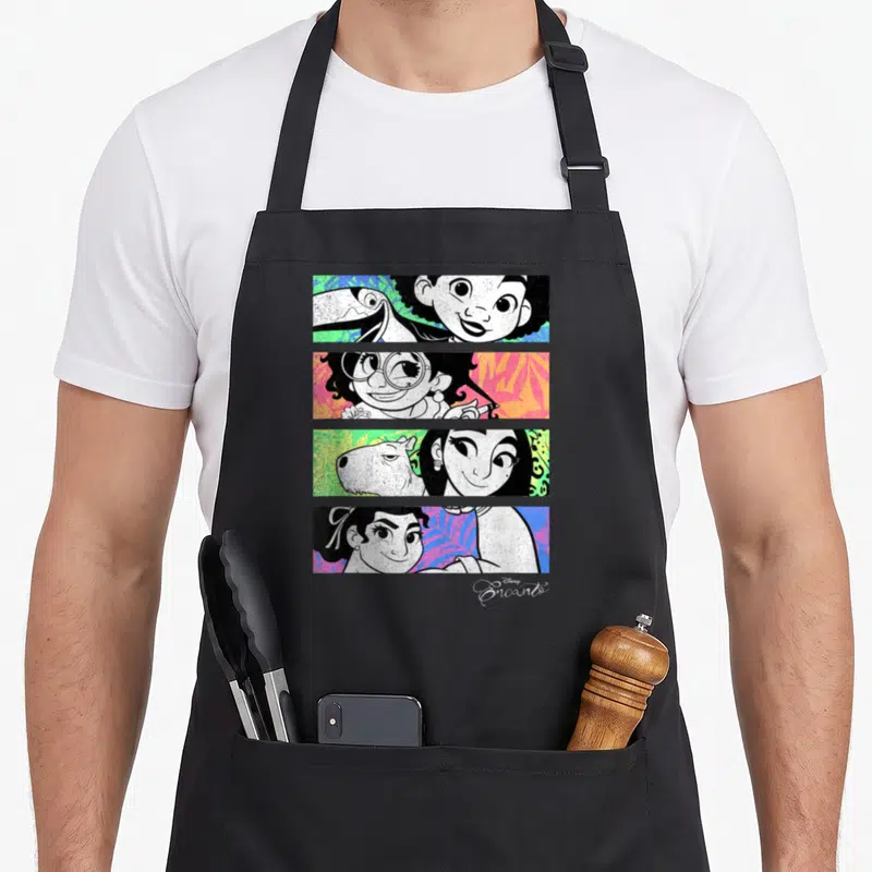 Panel personalized family aprons - Four stacked cartoon panels of characters and animals on colorful leaf backgrounds — shown on a black cotton canvas apron against a white background