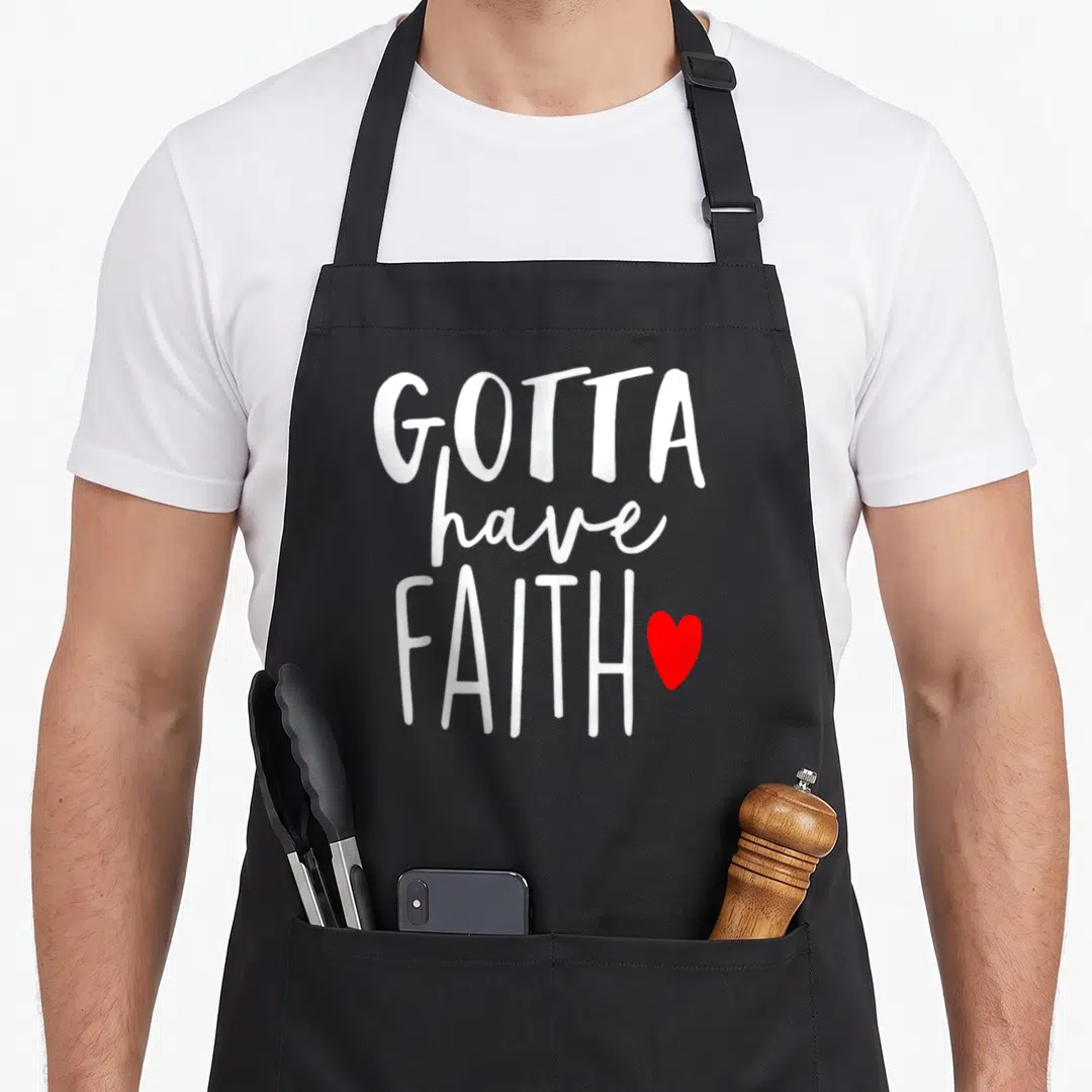 Christ christian catholic apron - White text Gotta have FAITH with red heart on 10 oz cotton canvas — shown on a black cotton canvas apron against a white background
