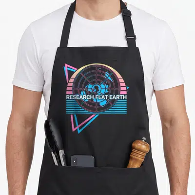 Research flat earther apron - Retro circular map with pink grid, blue stripes, and white RESEARCH FLAT EARTH text — shown on a black cotton canvas apron against a white background