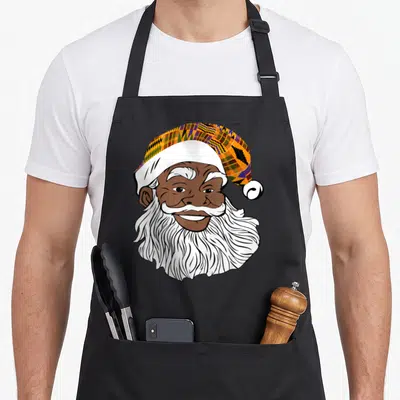 Jolly business apron - Cartoon Black Santa head with Kente pattern hat in orange purple yellow brown white — shown on a black cotton canvas apron against a white background