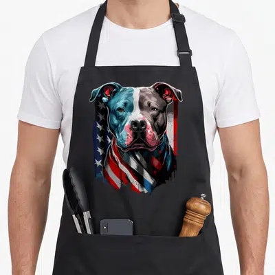 Patriotic dog dad apron - Realistic dog head with blue red white grey flag stars and stripes integrated into fur — shown on a black cotton canvas apron against a white background