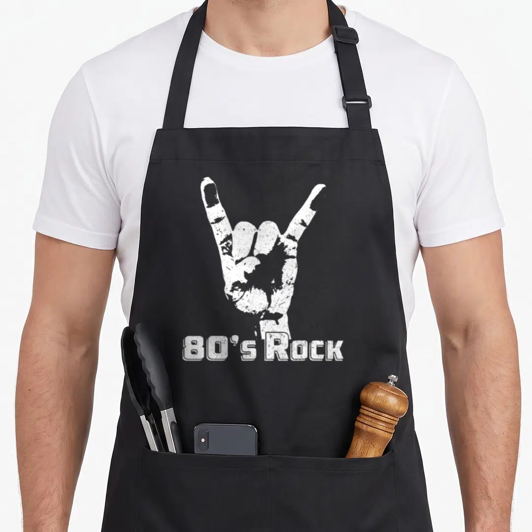 Rock 80s apron - White distressed hand rock sign above 80's Rock text — shown on a black cotton canvas apron against a white background