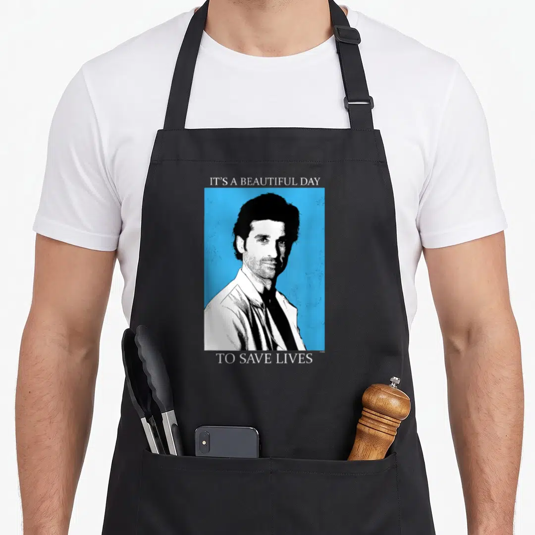 Save anatomy apron - Black and white man portrait on blue background with IT'S A BEAUTIFUL DAY TO SAVE LINES text — shown on a black cotton canvas apron against a white background