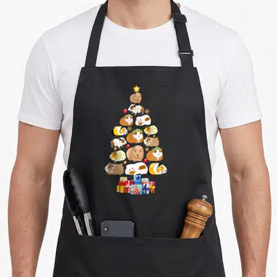 Guinea christmas tree apron - Cartoon guinea pigs in a tree shape with star and gifts — shown on a black cotton canvas apron against a white background