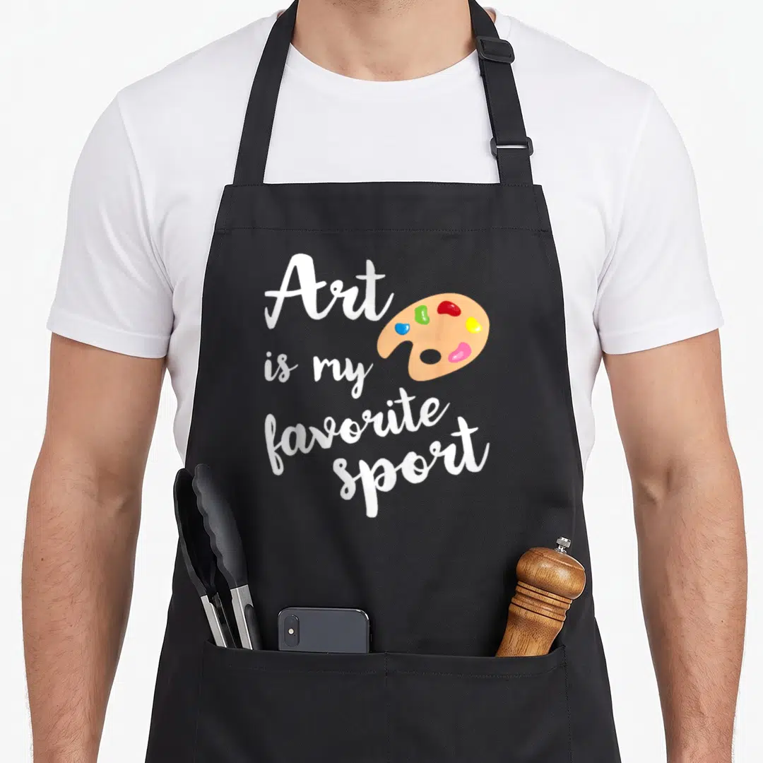 Sport painter apron - White script text next to tan palette with red blue yellow green and pink blobs — shown on a black cotton canvas apron against a white background