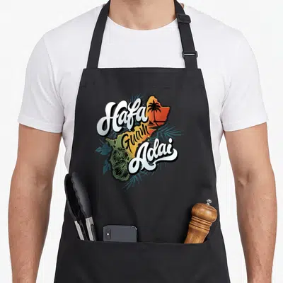 Island hafa guam aprons - Retro map of Guam with Hafa Adai text, hibiscus, and palm tree in orange and teal — shown on a black cotton canvas apron against a white background